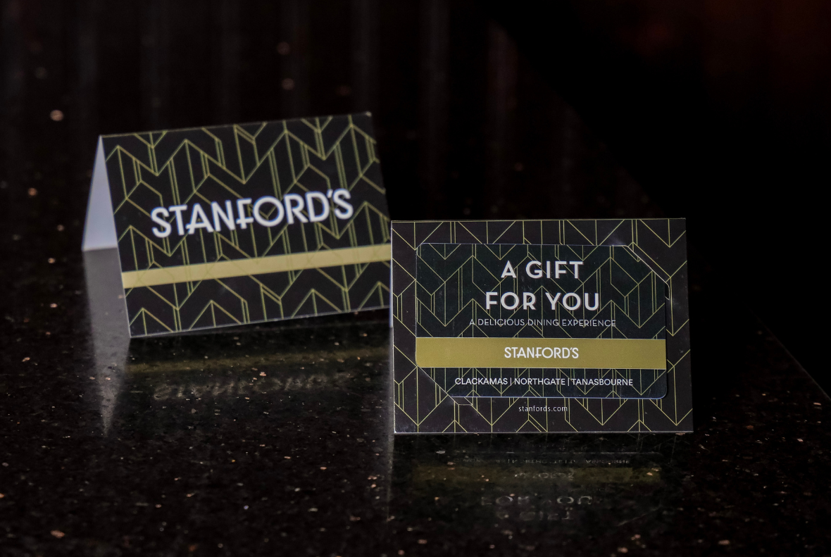 Two gift cards to Stanford's Restaurant and Bar on a table top.